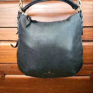 Kate Spade black purse Leather w/stripe interior, expansion zipper base.